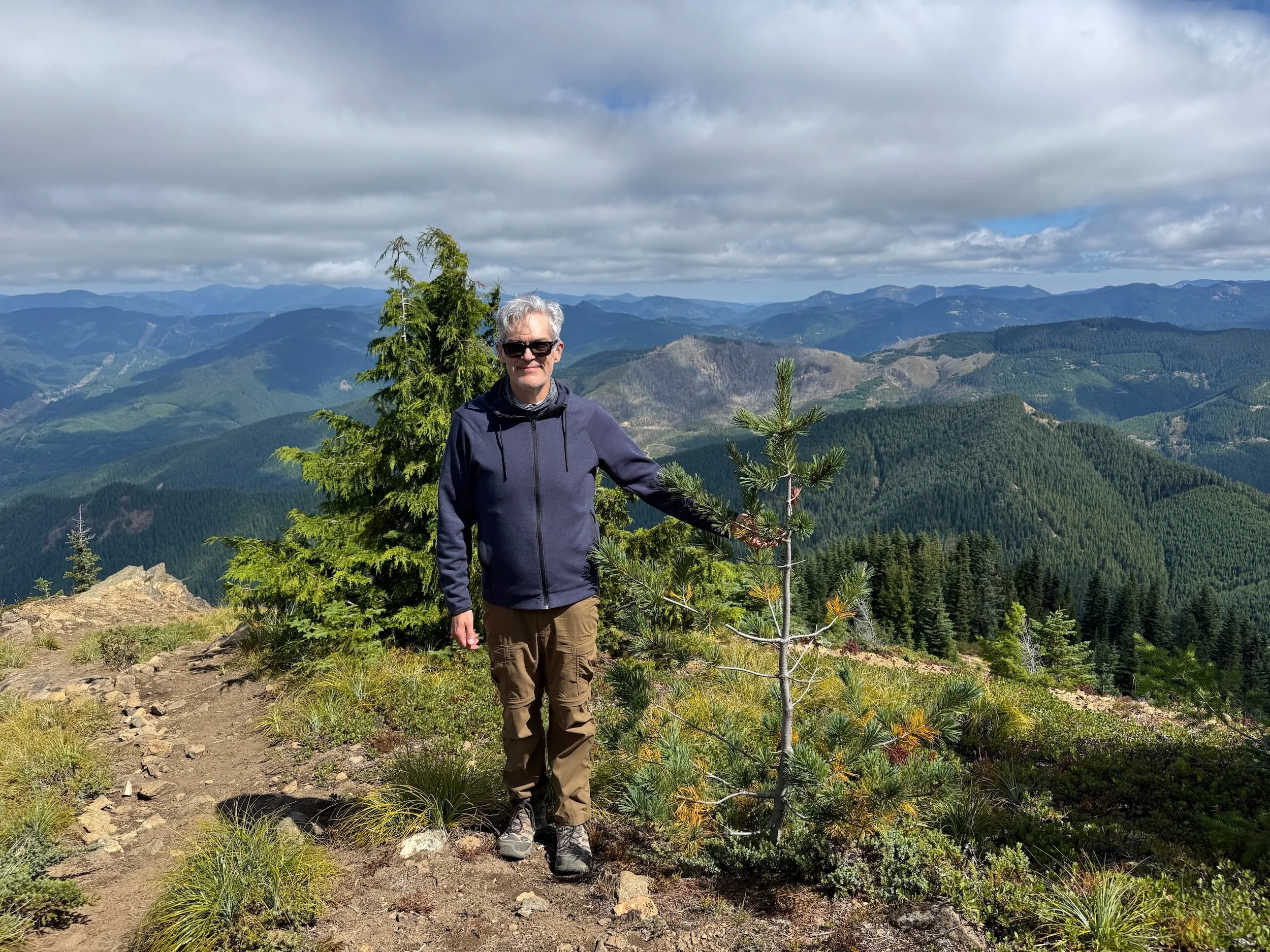 Rich standing beside the compact western white pine that fooled him in the high-elevation conifer community.