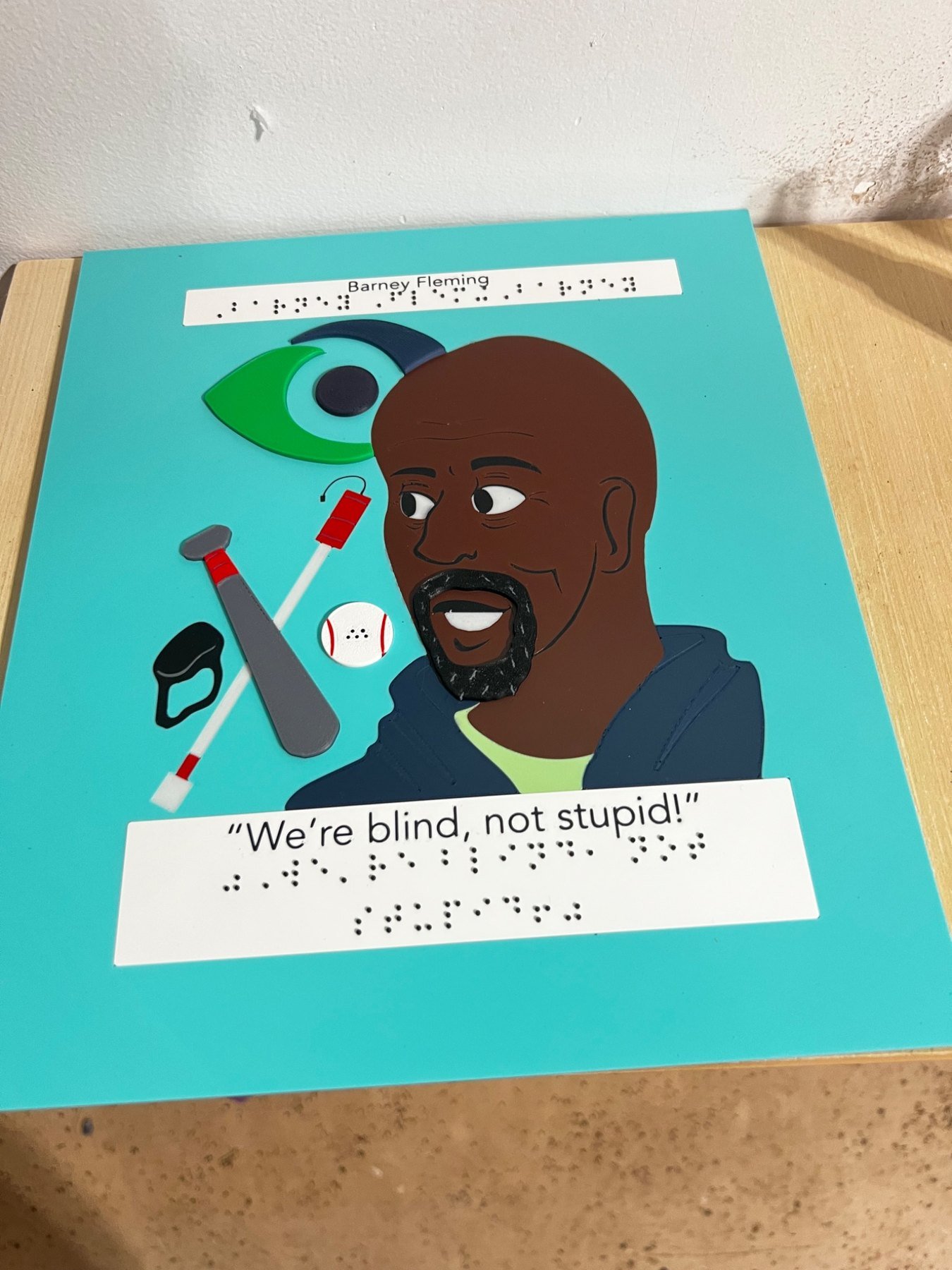Accessible tactile nonprofit art display with raised graphics and Braille