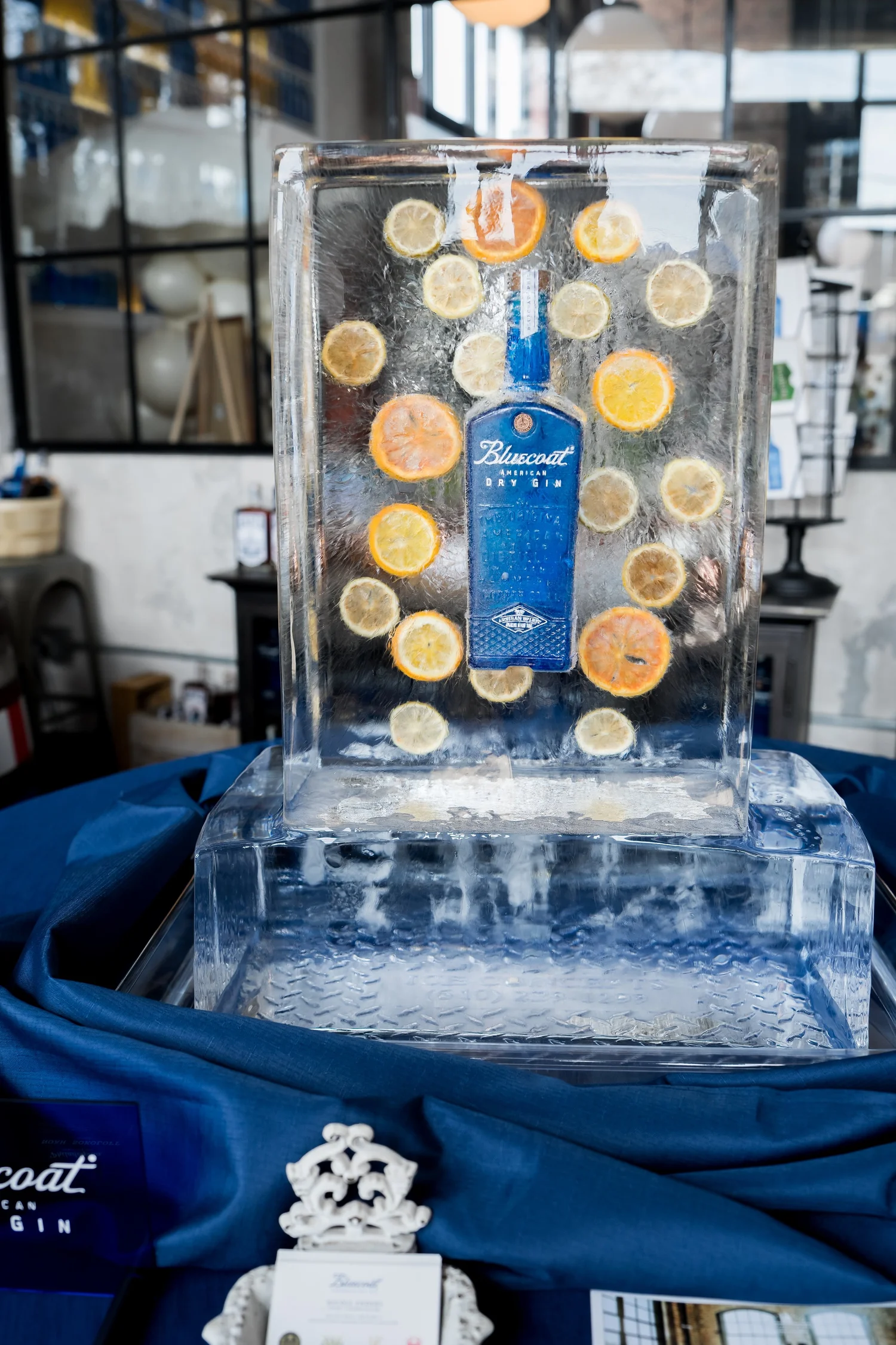 Bluecoat Gin bottle and oranges displayed inside a custom ice sculpture