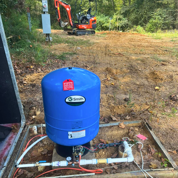 Well pressure tank installation on a rural property