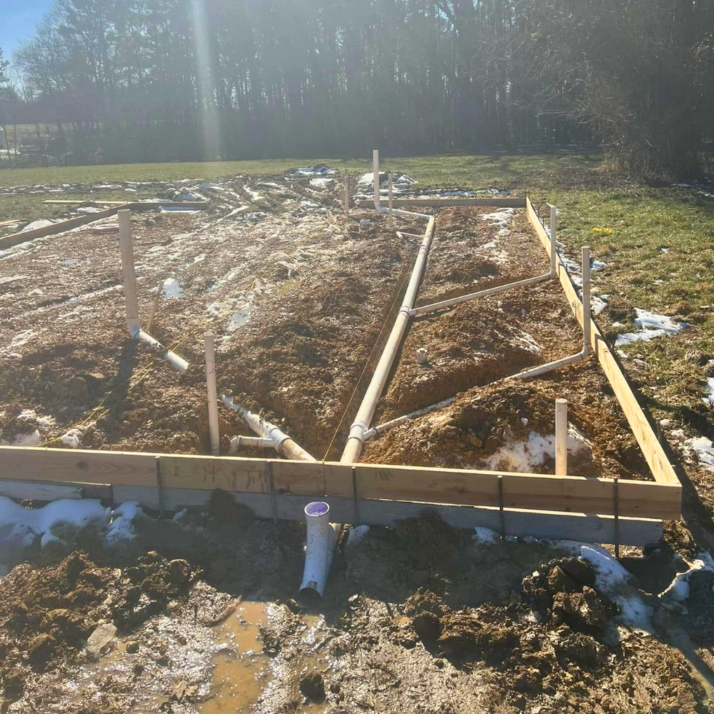 Under-slab plumbing rough-in inside foundation forms