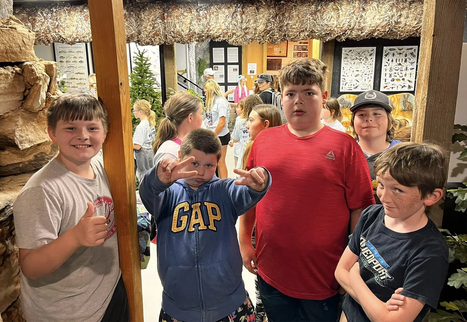 Children visiting the Nature Center exhibit area with educational displays and natural-history panels behind them