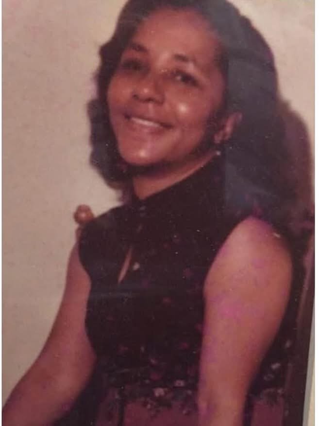 Portrait of Chéla’s grandmother, Rosetta Wallace Lewis, wearing a black top