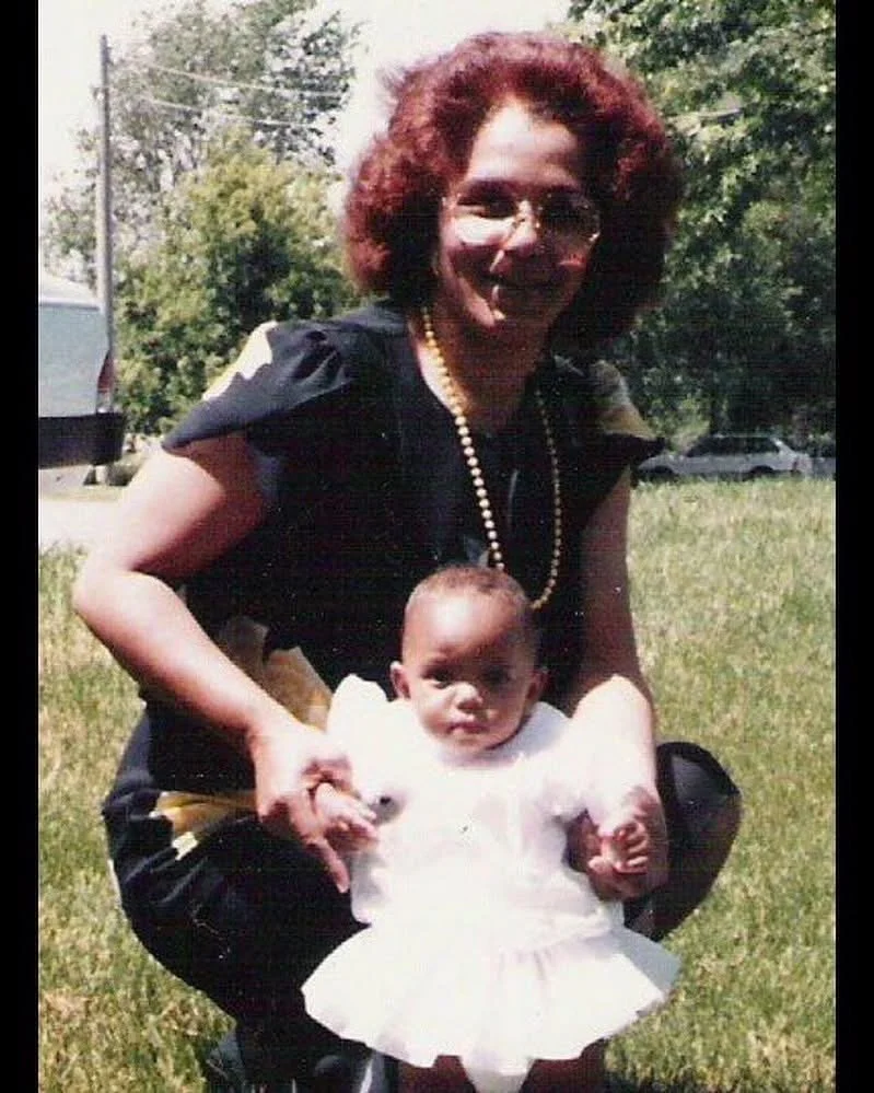 Mother embracing her daughter in a flowering garden