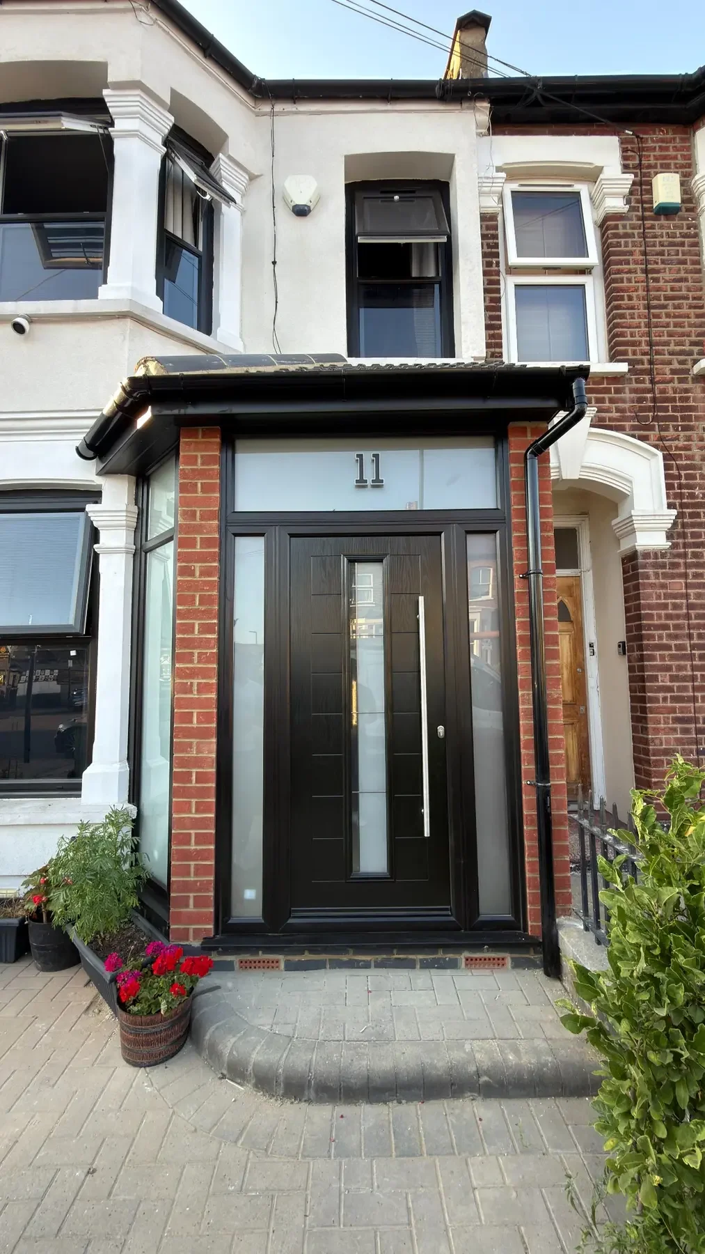 Completed Bergmann Windows entrance with black windows, a composite door and glazed porch