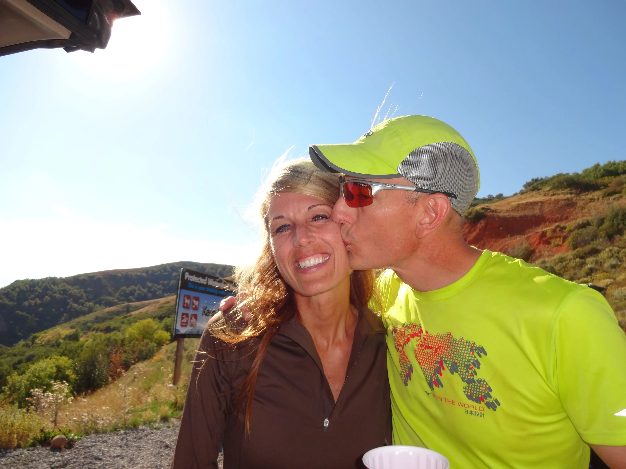 Johnny giving his wife a kiss on the cheek