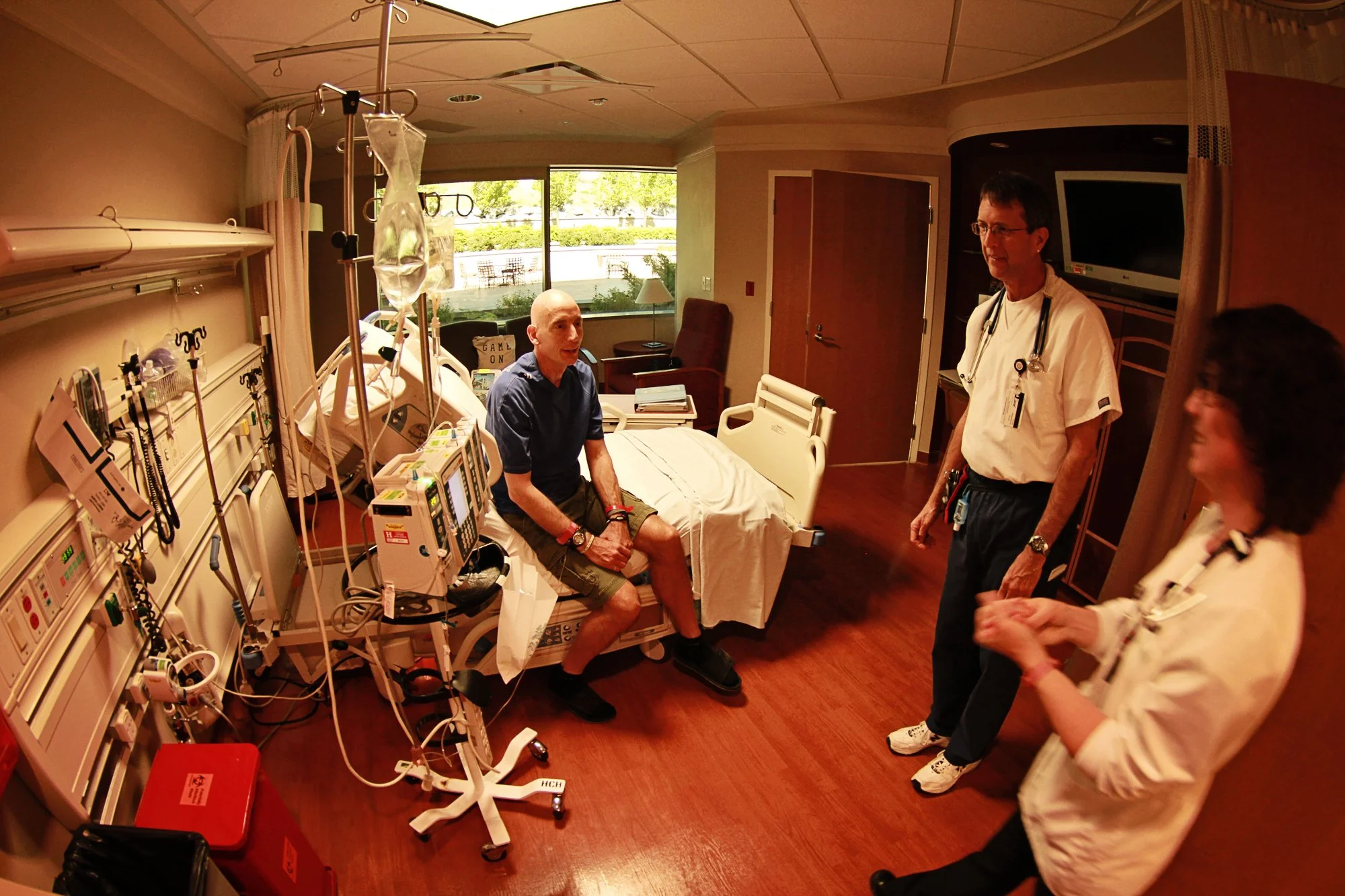 Johnny in hospital room talking with doctors