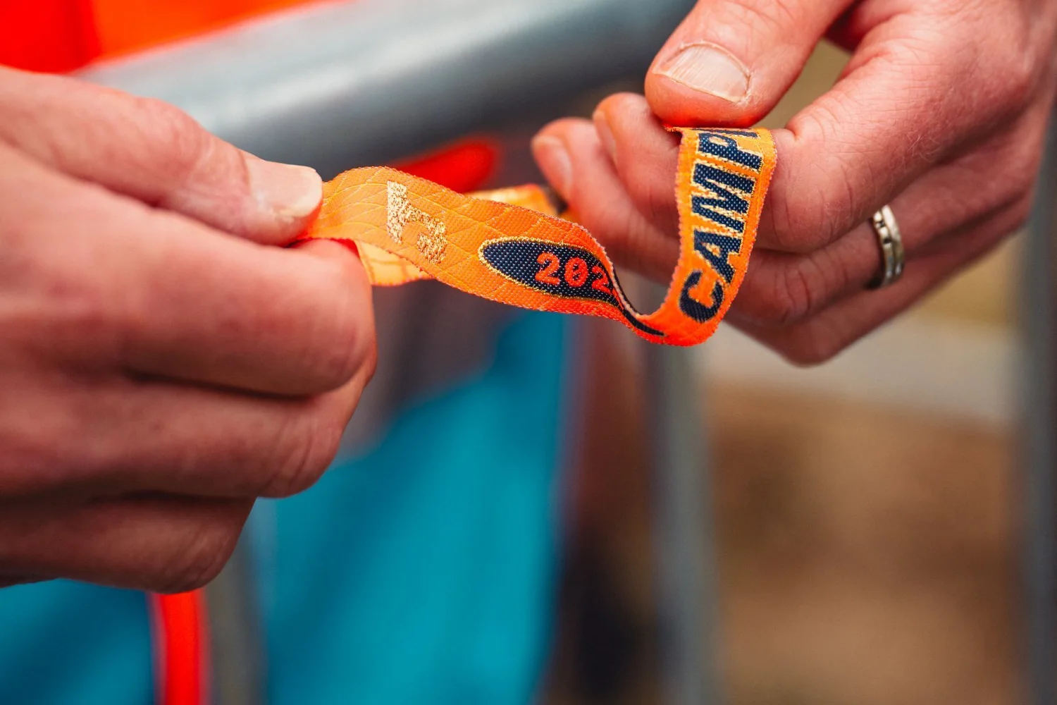 Steward checking a guest wristband at a festival entry barrier