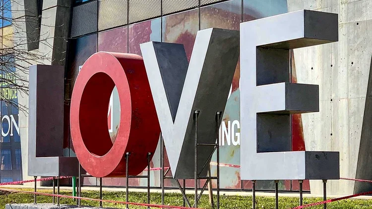Then LOVE Emerges at its original Reston Station installation, with a red terrazzo O and gray concrete letters.
