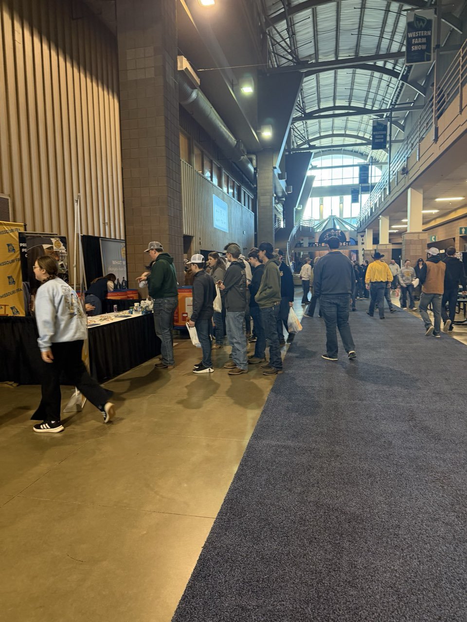 Crowds moving through the aisles of a regional farm show
