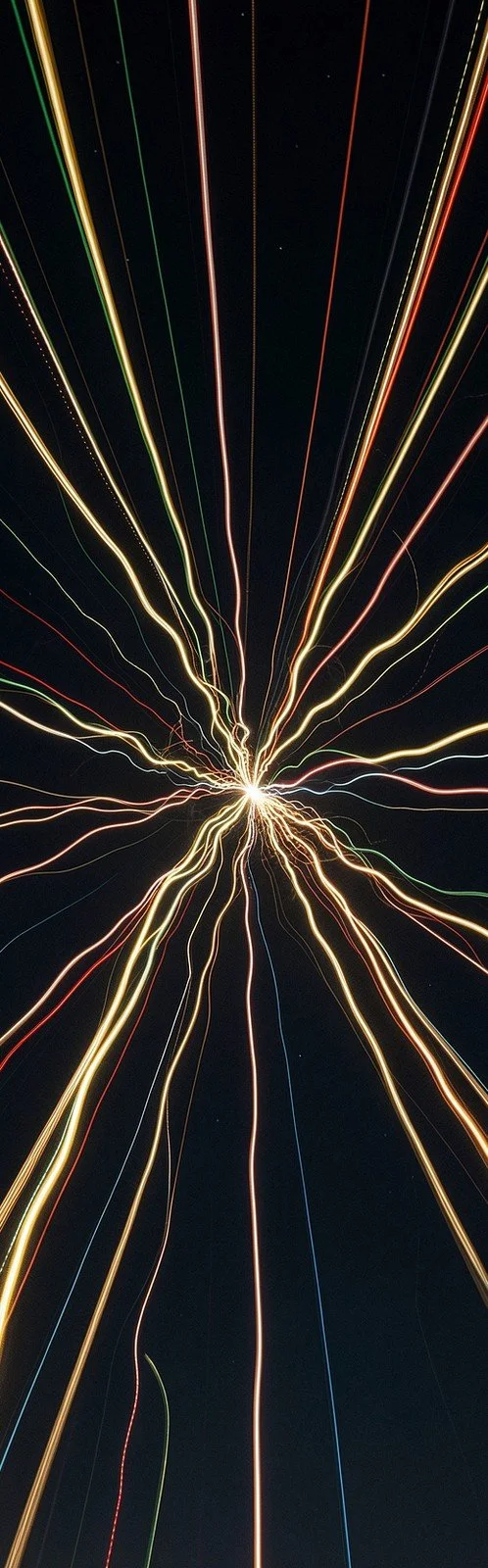 Streaks of colored light radiating from a single point
