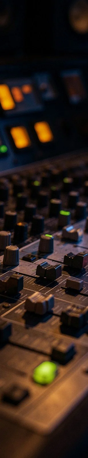 Recording studio mixing console with glowing knobs
