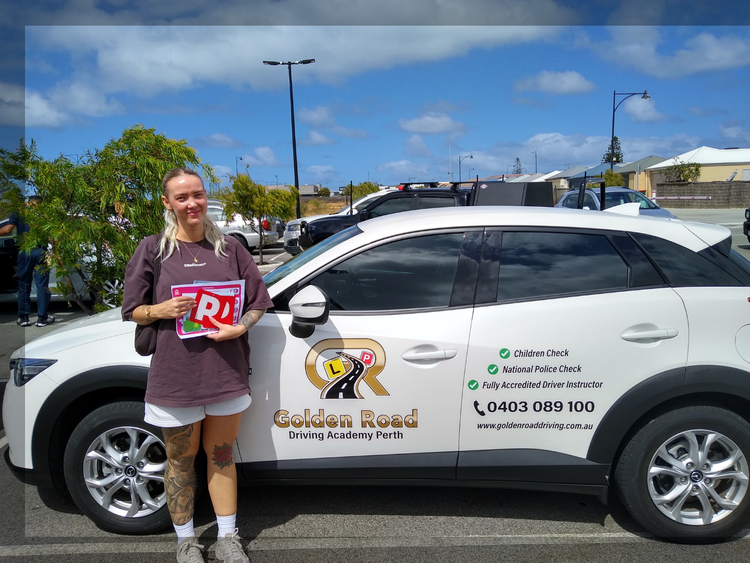 Rebecca Fletcher with P plates after passing the driving test