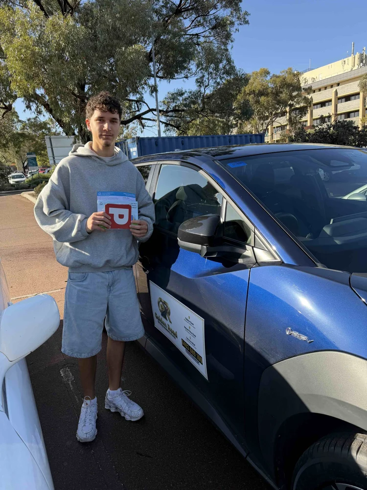 Dean Jolly with his P plates after passing his driving test first time
