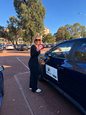Jean Brennan with her P plates after passing her driving test at Joondalup with Golden Road Driving Academy
