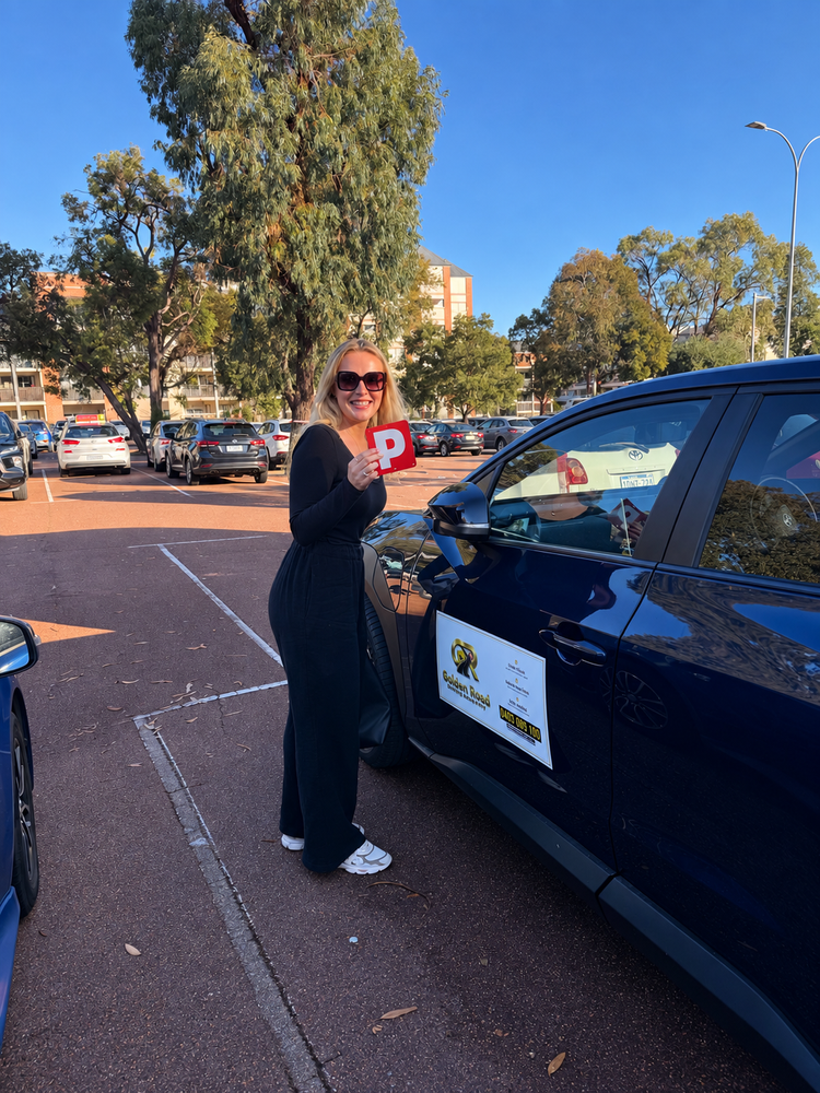 Jean Brennan with her P plates after passing her driving test at Joondalup