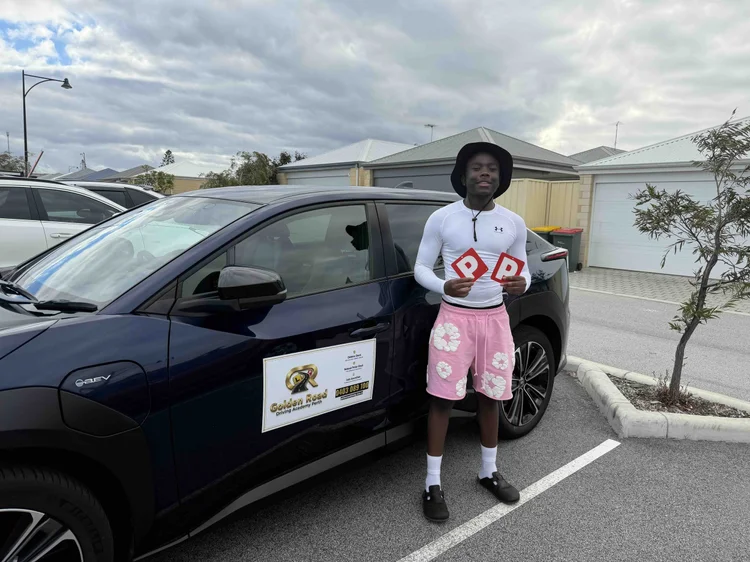 Nhlanhla Mpofu's son with his P plates after passing his driving test