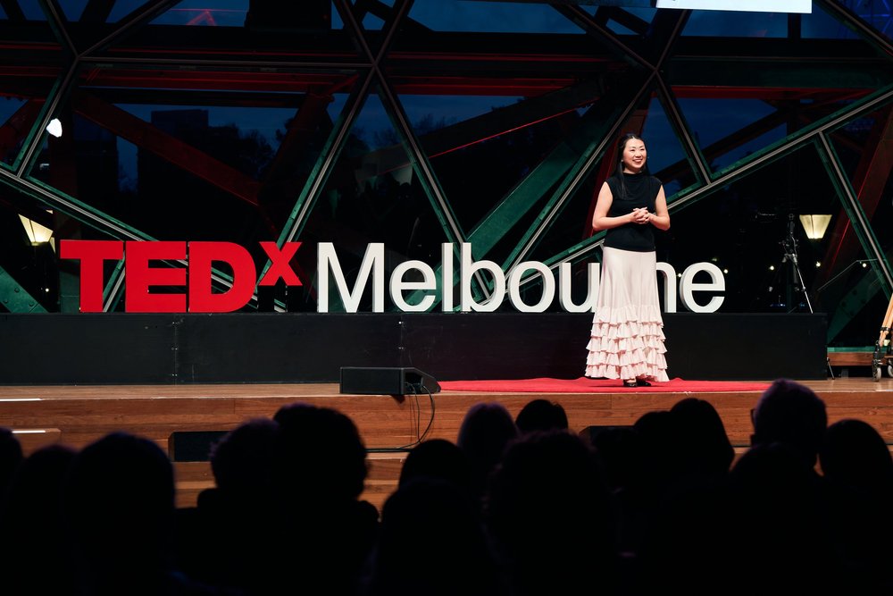 Zen Zeng speaking on the TEDxMelbourne stage