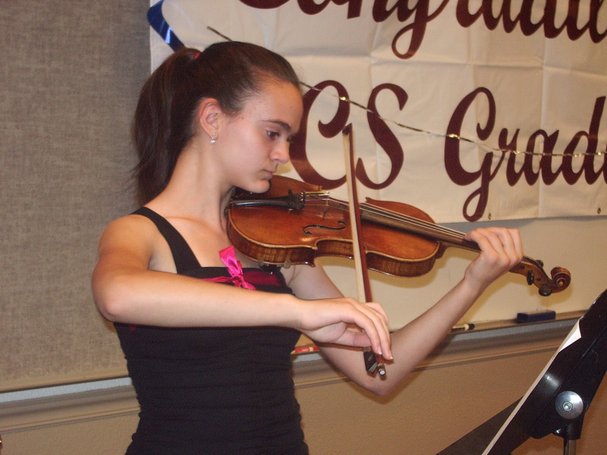 A Solomon International School student performing on violin