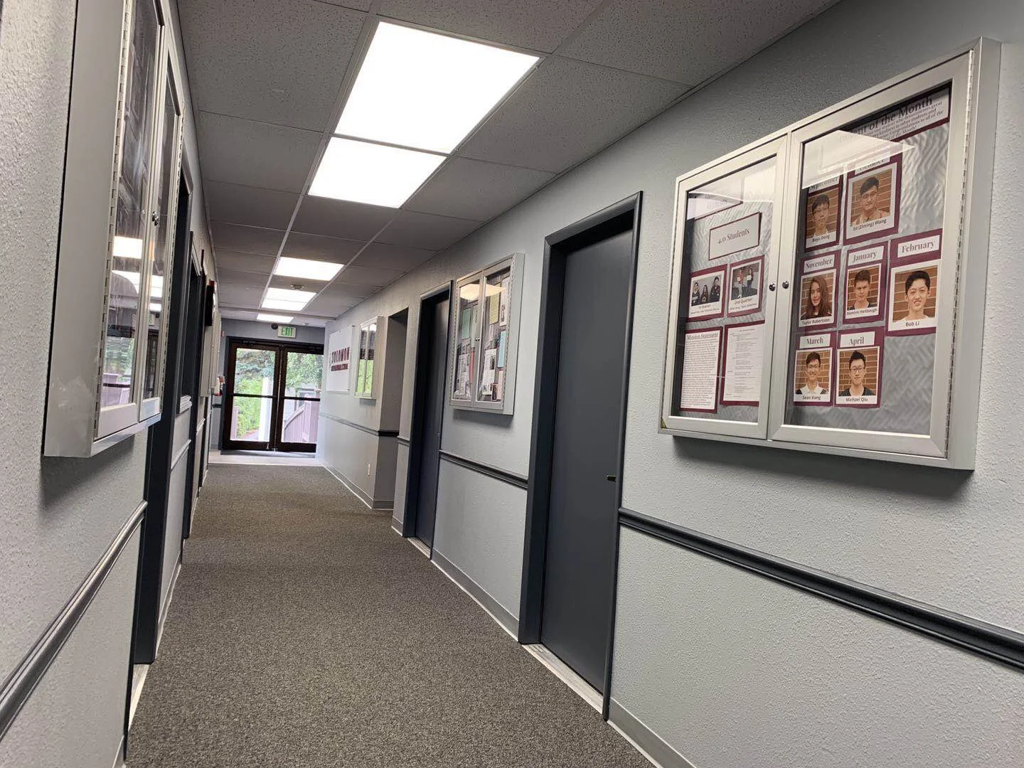 A Solomon International School hallway with student recognition boards
