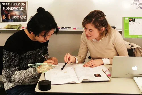 An SIS teacher working one-on-one with a student
