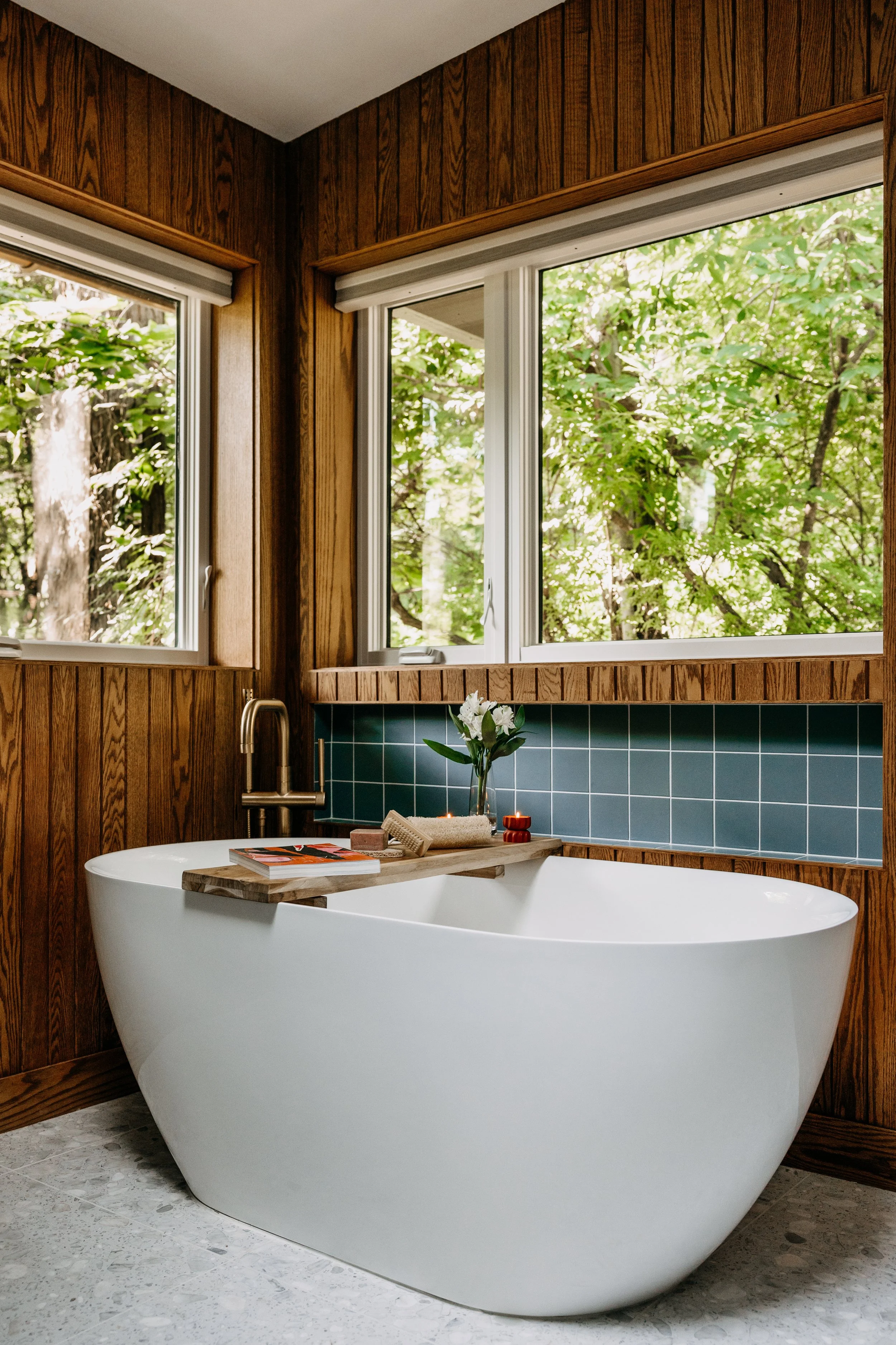 Bathroom soaker tub set against handcrafted walnut paneling