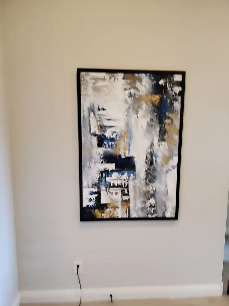 Tall abstract art hung in a Phoenix rental home hallway