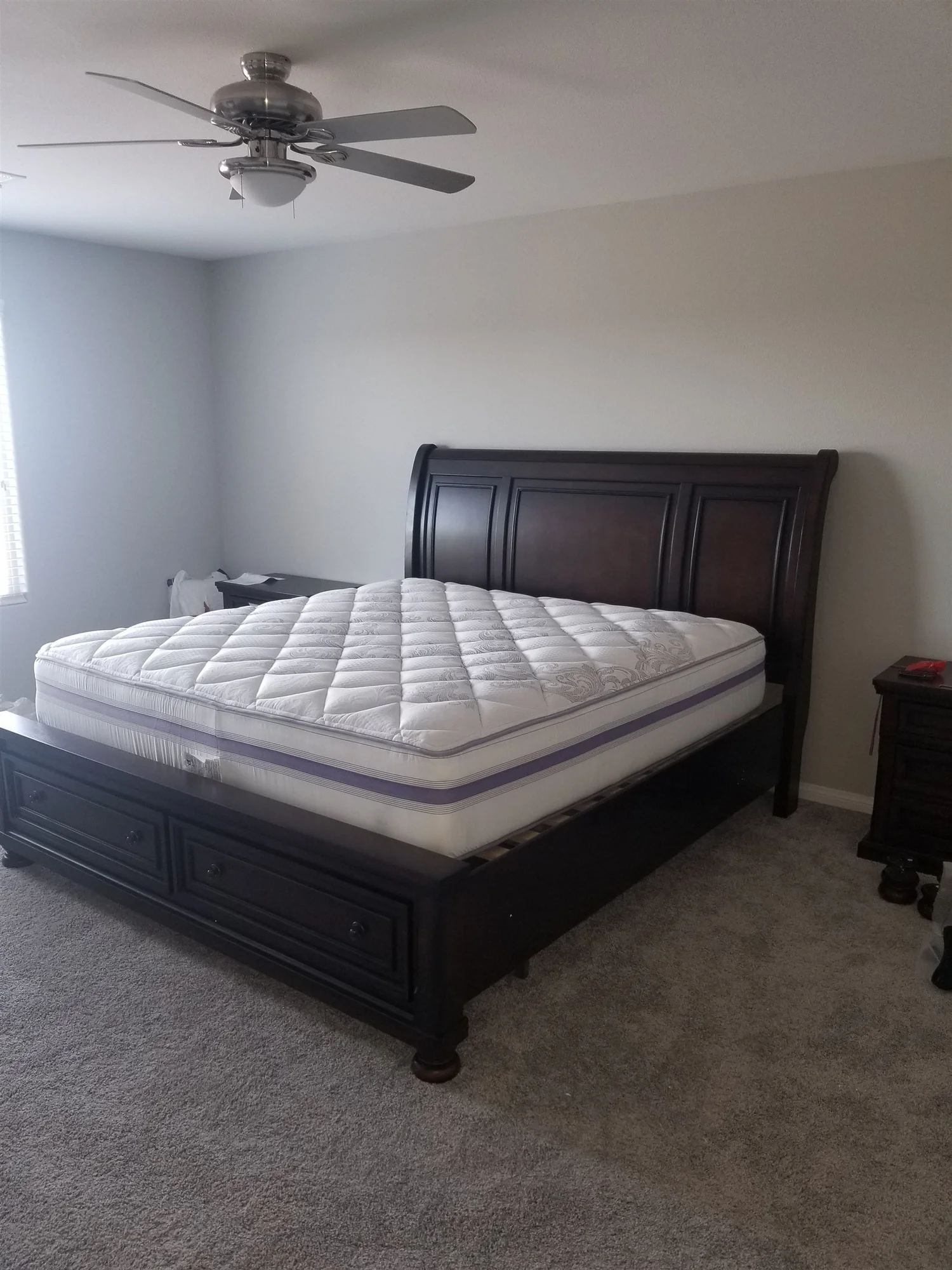 Sleigh bed with storage drawers and a nightstand assembled in a Phoenix bedroom