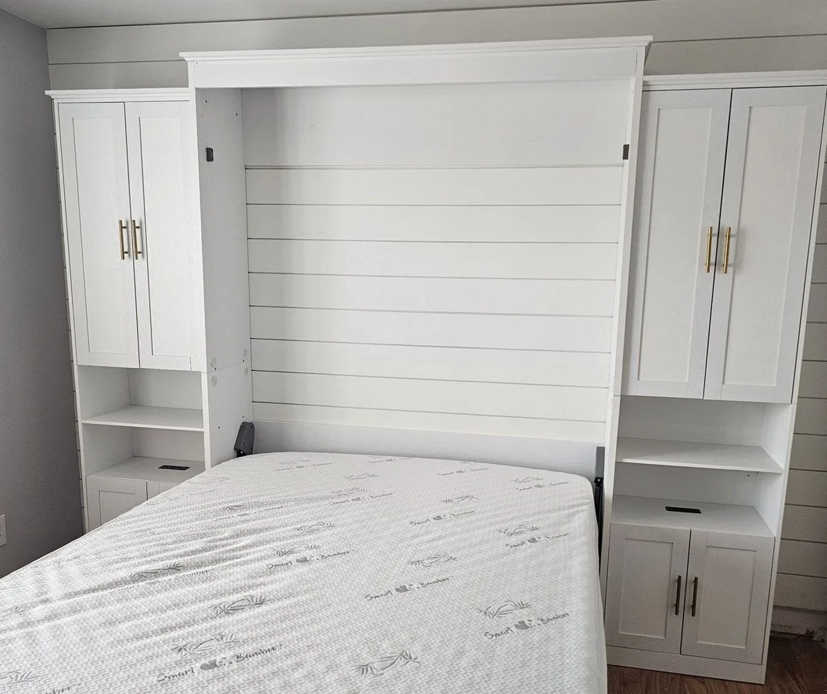 White Murphy bed wall unit with storage towers assembled and mounted in a Phoenix bedroom