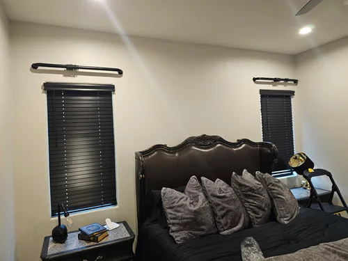 Black blinds installed on two bedroom windows in Phoenix
