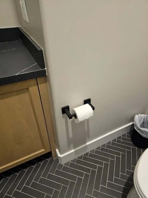 Black toilet paper holder installed in a Phoenix bathroom