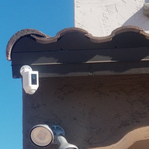 Security camera mounted under a tile roofline in Phoenix