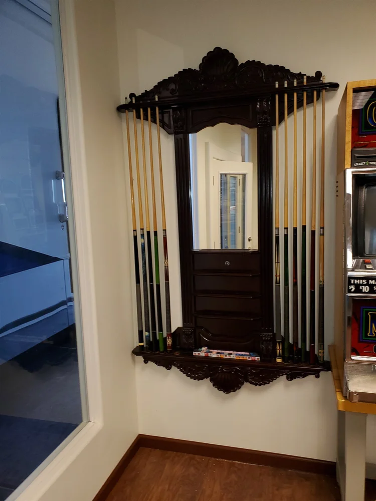 Wall pool cue rack mounted in a Phoenix game room