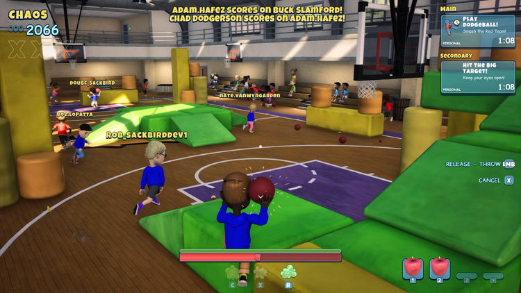 A wide view of a gymnasium dodgeball match, a dozen kids in play and a ball held ready to throw