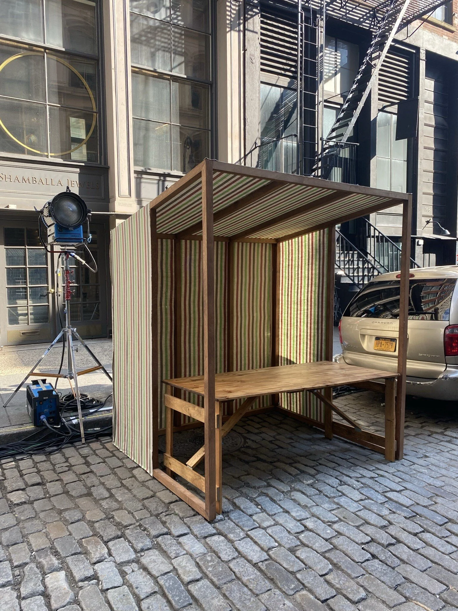 Long Temporary outdoor installation with wooden structure and event seating