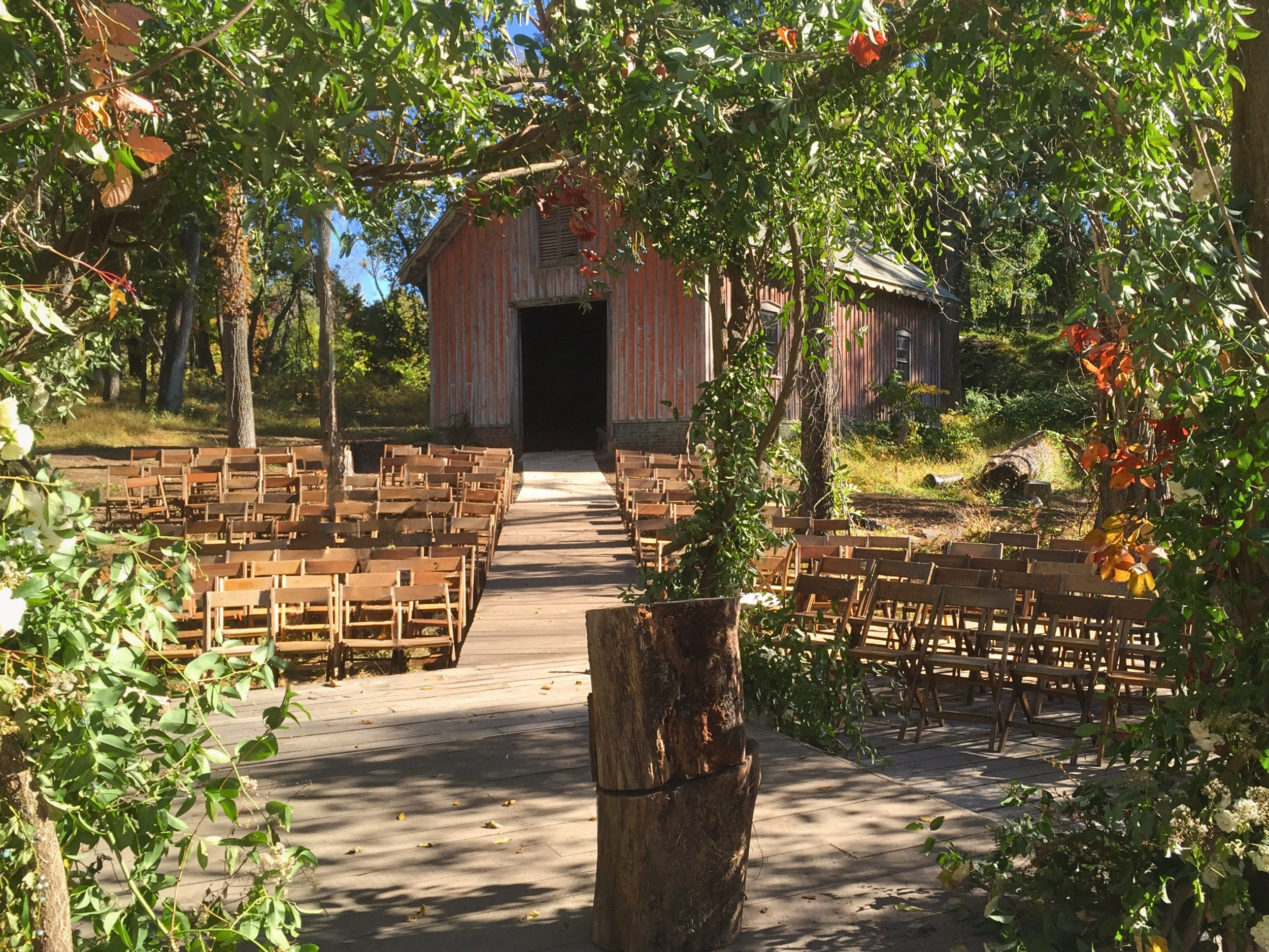 Handmade folding farm tables paired with vintage wooden folding chairs for an outdoor wedding reception at Corto Jersey City