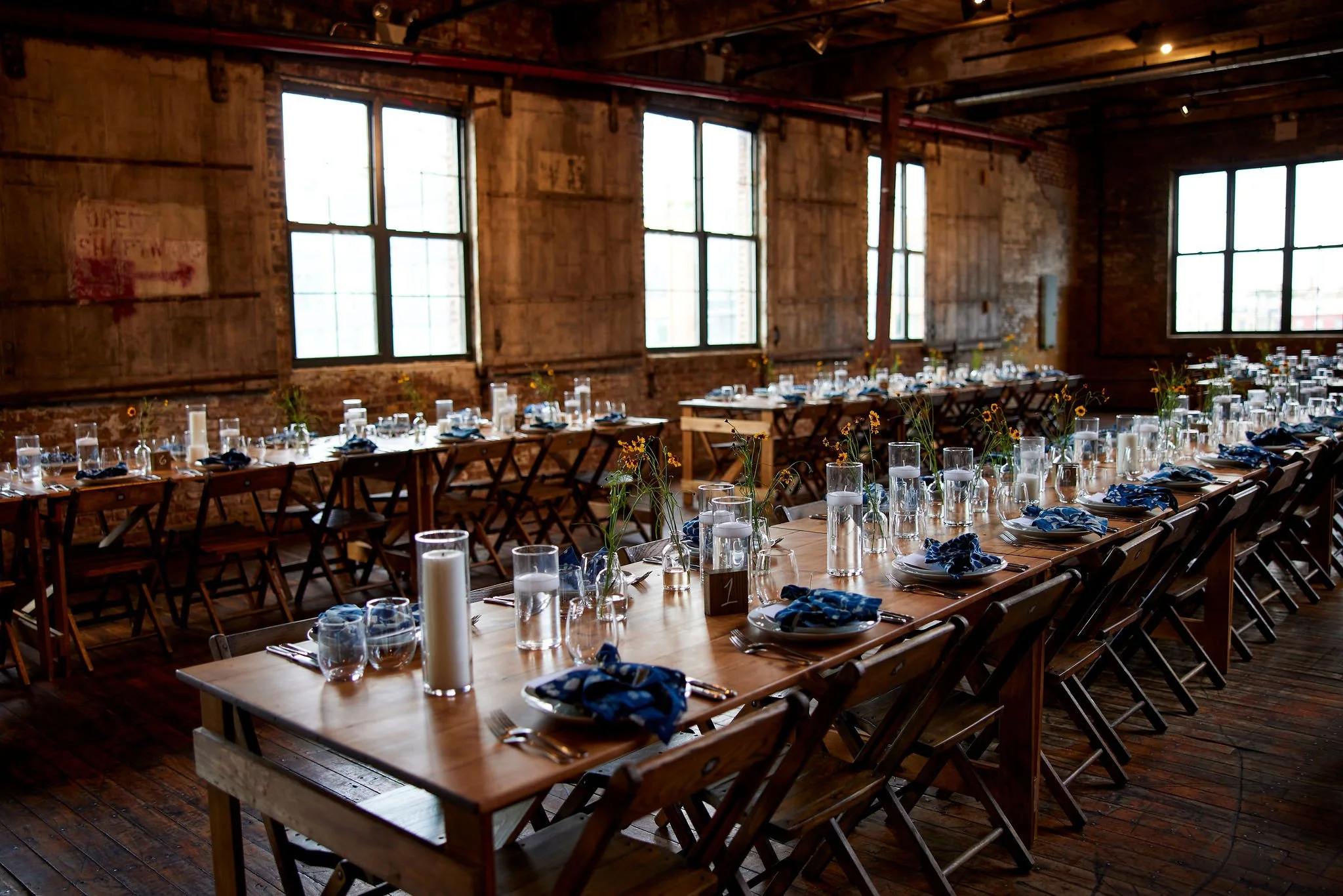 Long farmhouse table setup in a Williamsburg loft