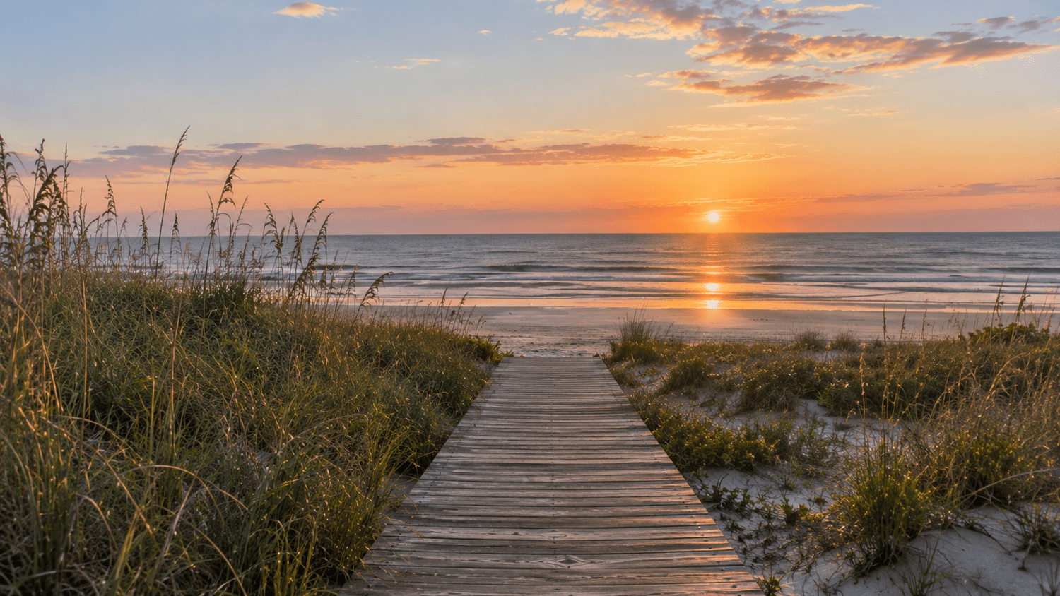 Kiawah Island boardwalk leading through coastal dunes toward the Atlantic Ocean at sunrise
