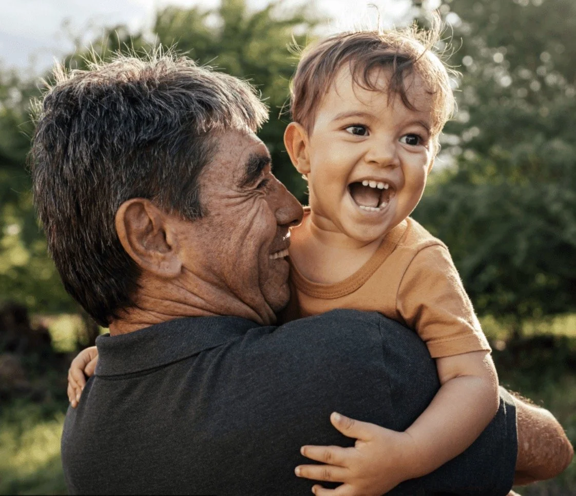 A grandfather holding his young grandson