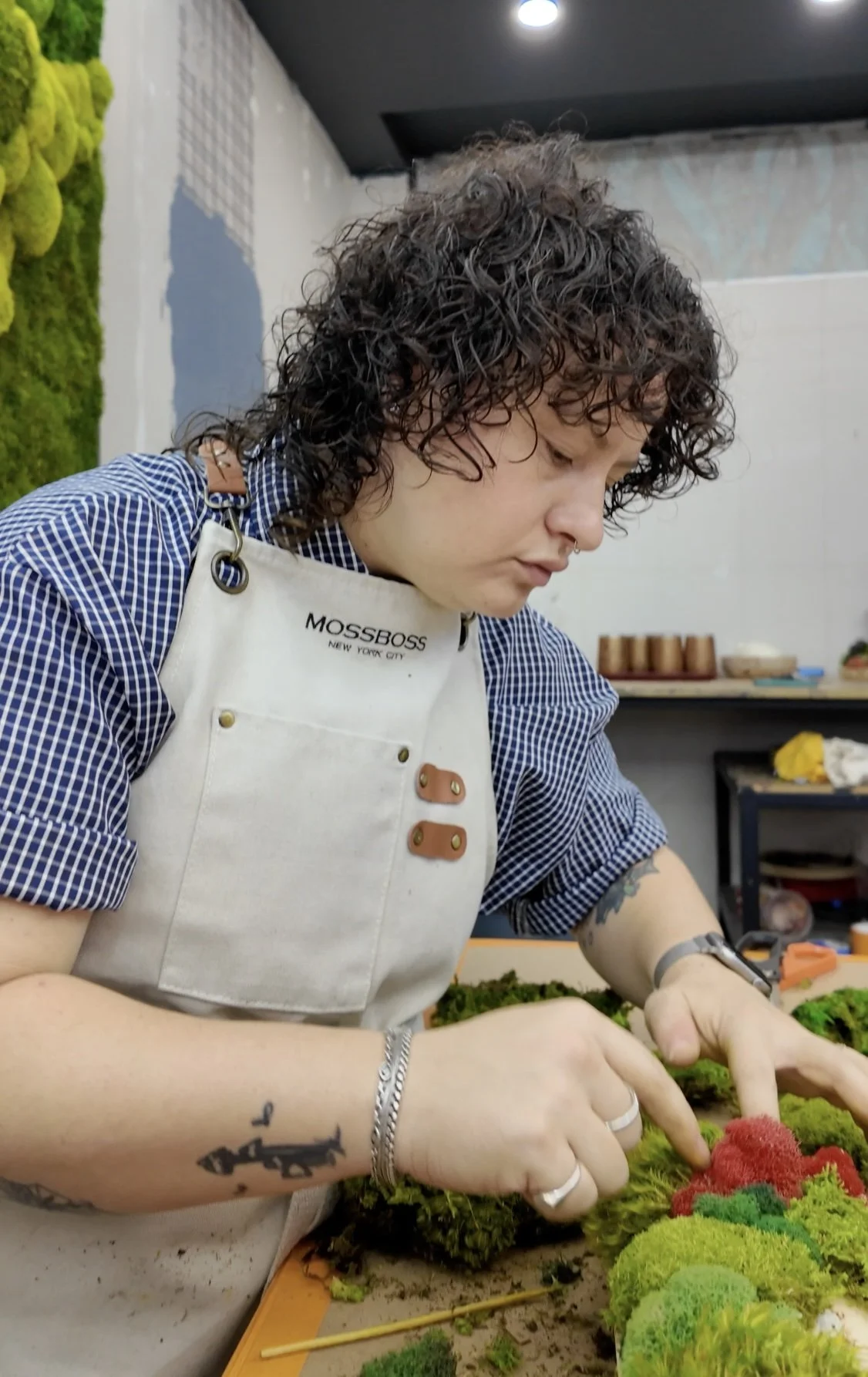 Placing reindeer moss into a bowl during a MossBoss class