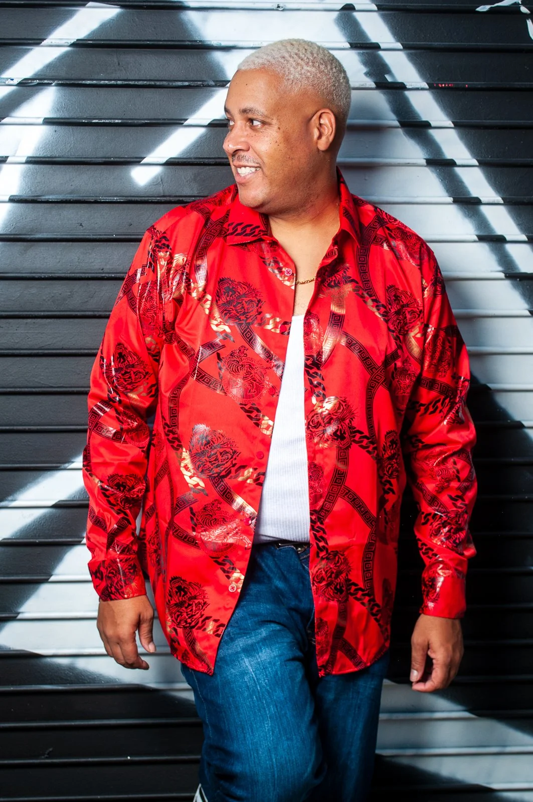 DJ Epps smiling in red shirt