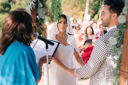 Shana and Mitchell at the ceremony arch at Victoria Ranch