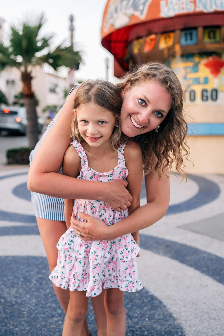 A mother and daughter laughing together during a day in the life session