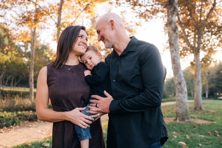 Parents holding their toddler between them on the Jeffrey Open Space Trail in Irvine