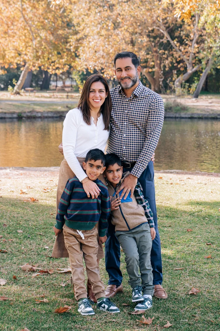 The Sondhi family, all four looking at the camera and smiling, during an Orange County family session