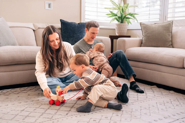 The Palladino family playing on the living room floor during their in-home session in Irvine