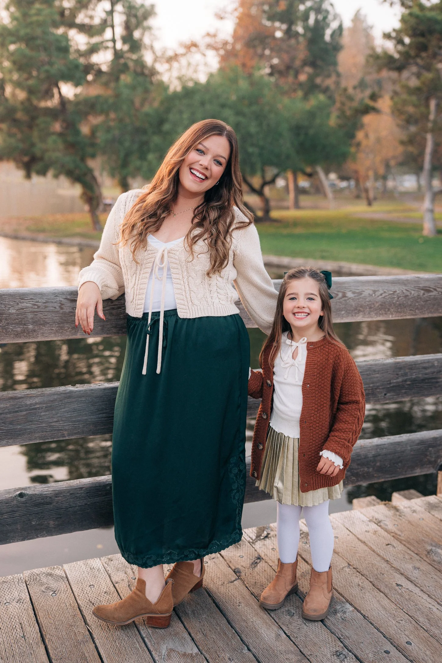 Mom and daughter standing together on the wooden dock at Yorba Regional Park