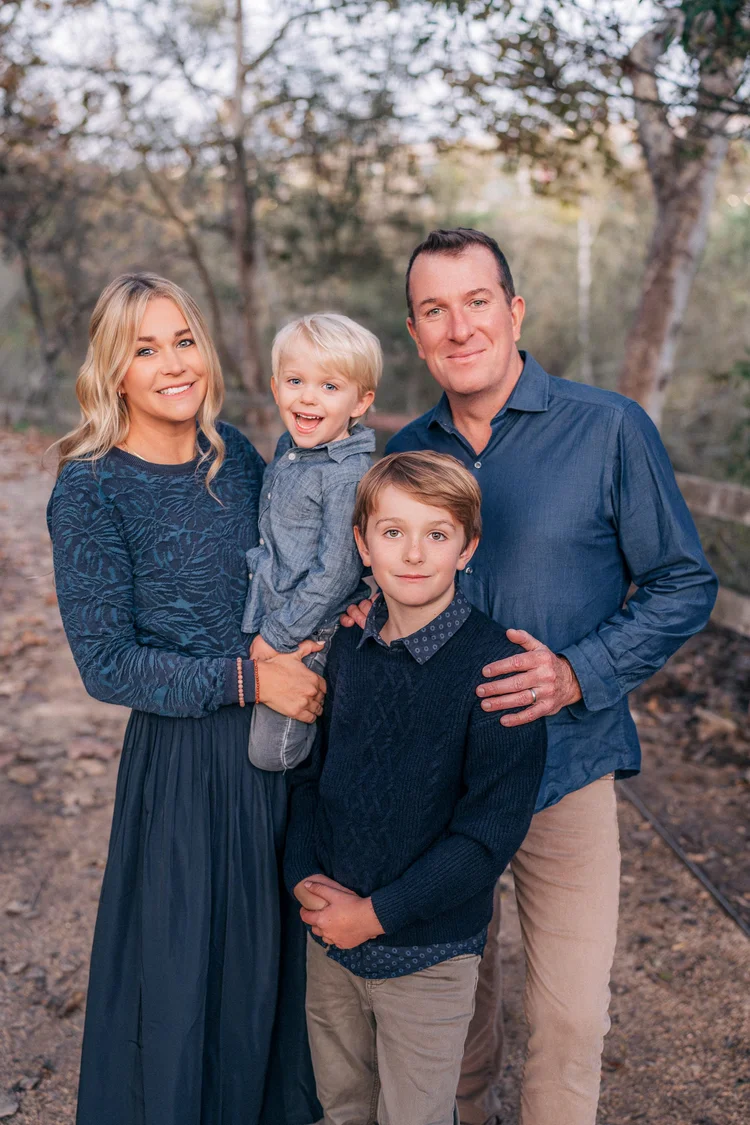 The whole family of four standing together