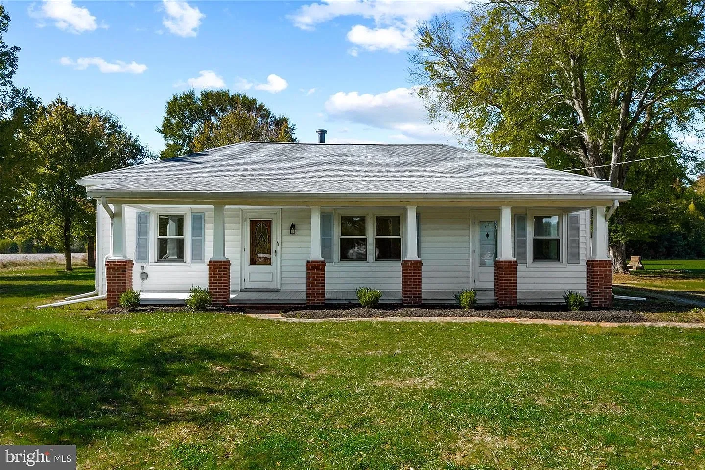 Front of 20525 Point Eastern Drive, Ruther Glen, VA, a single-story home with a covered front porch and brick columns