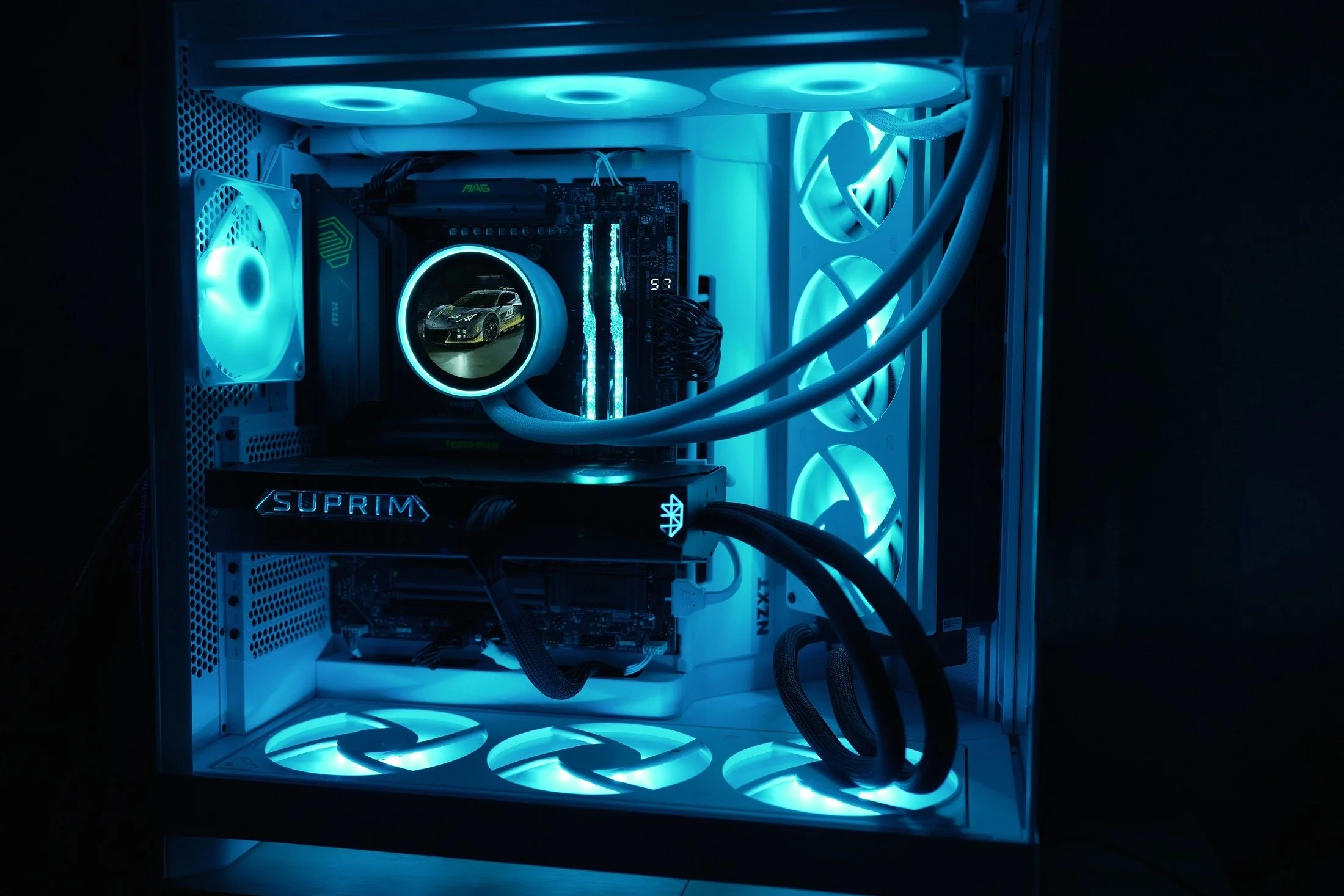A DLB PC with a SUPRIM graphics card, liquid cooling and blue lighting.